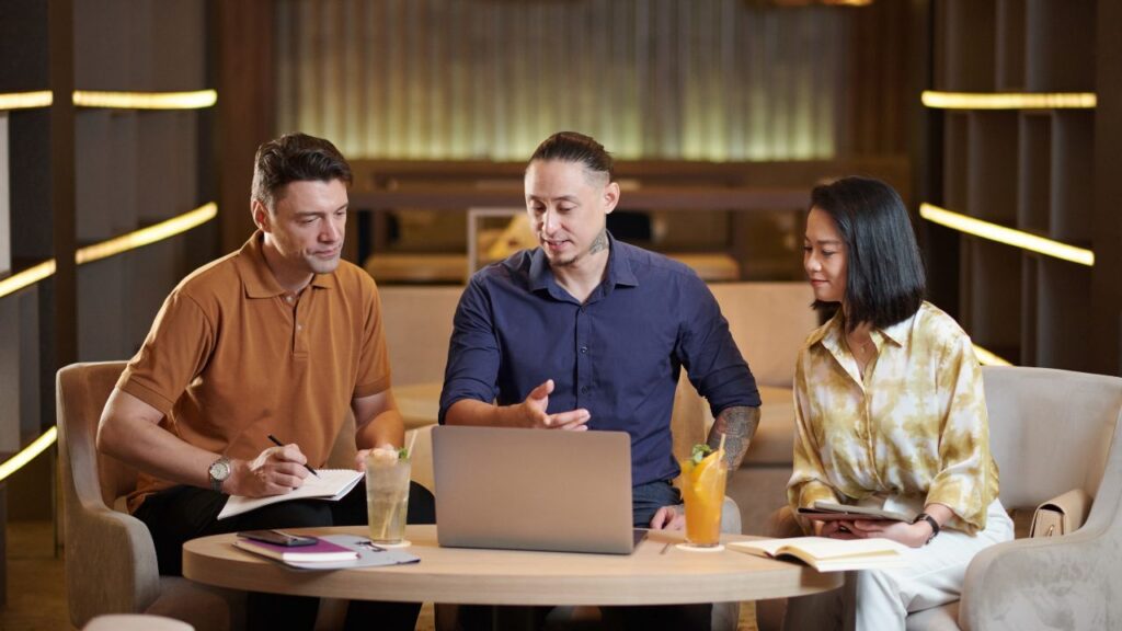 Professionals chatting in a coworking lounge area.